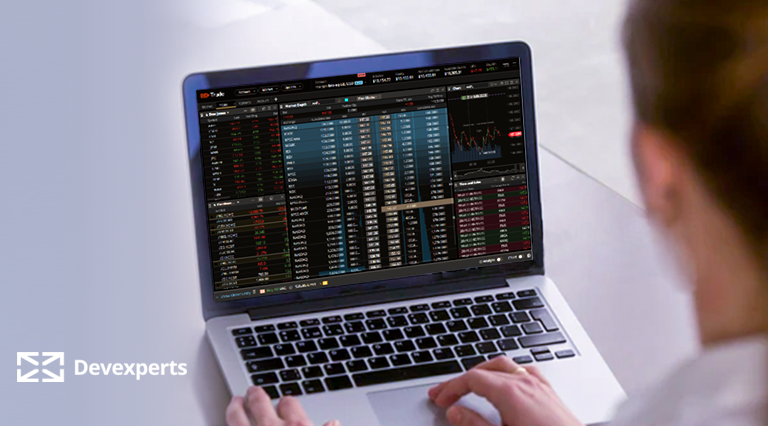 The UI of DXtrade XT by Devexperts on a laptop, showing a person managing their portfolio